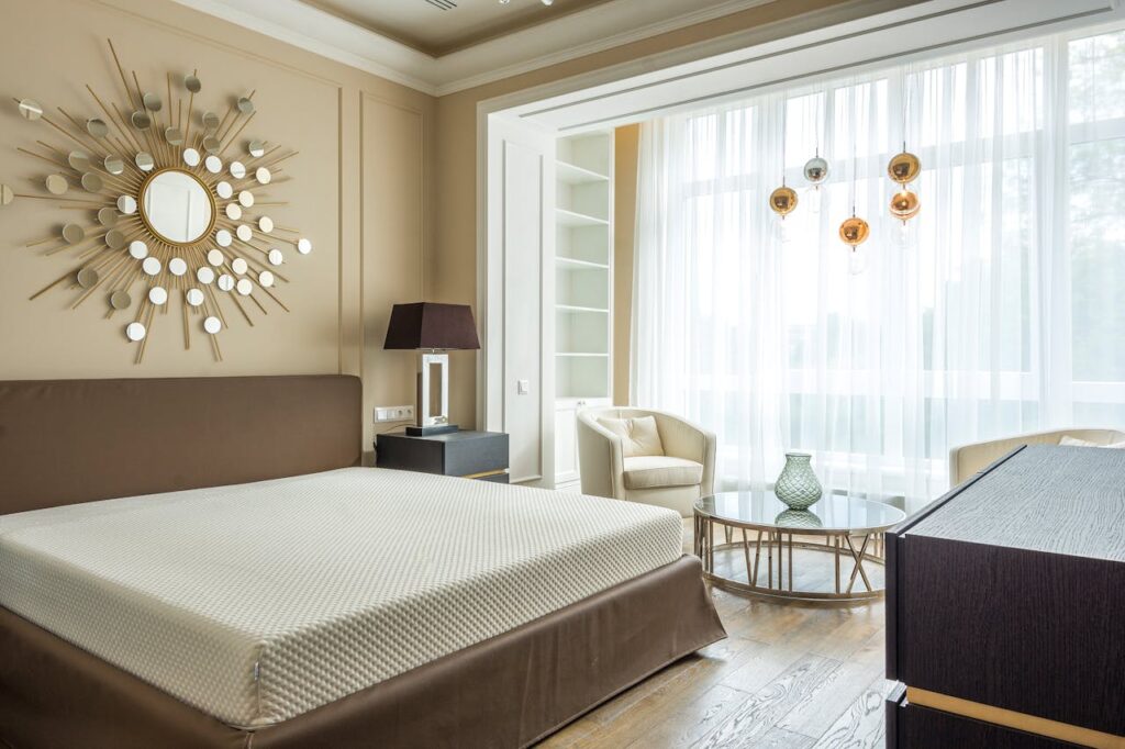 Elegant small expat bedroom with natural light and space-saving furniture for a cozy home environment.